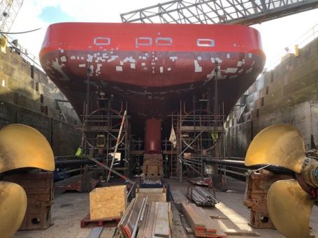 Ship stern with propellers removed and specialist relining works underway to both Kort nozzle - Corrotec marine engineering solutions Wirral
